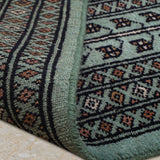 Neerjavan – Hand Knotted Wool Rug in Coral Green/Black