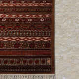 Raktambar – Hand Knotted Wool Rug in Maroon/Orange Rust