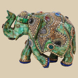 Regal green camel bone elephant sculpture intricately decorated with gold-toned metalwork and colorful gemstone inlays, showcasing traditional Indian craftsmanship