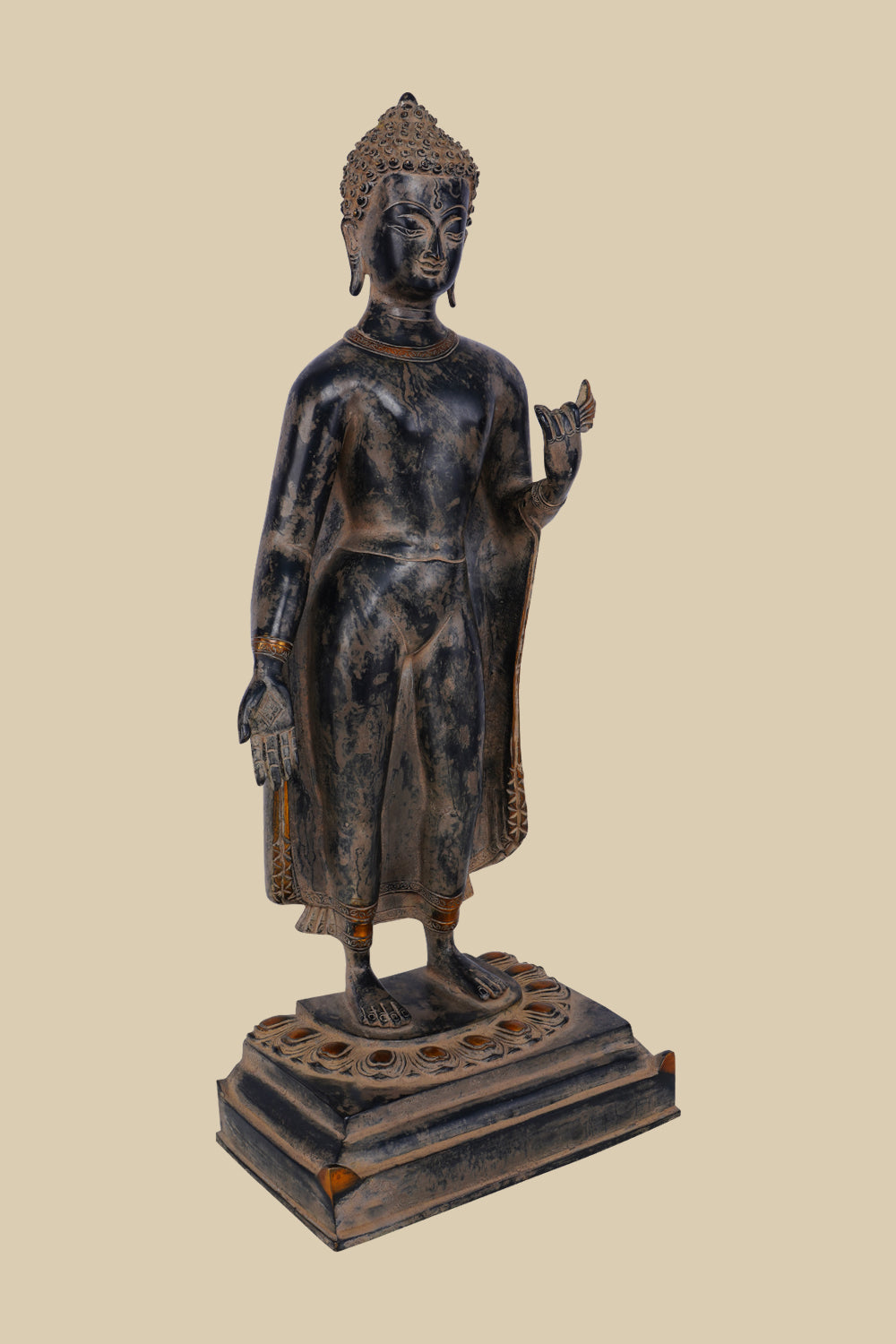 Brass sculpture of Lord Buddha standing with one hand raised in the Vitarka mudra (gesture of teaching and discussion), wearing flowing robes and standing on a detailed lotus pedestal.
